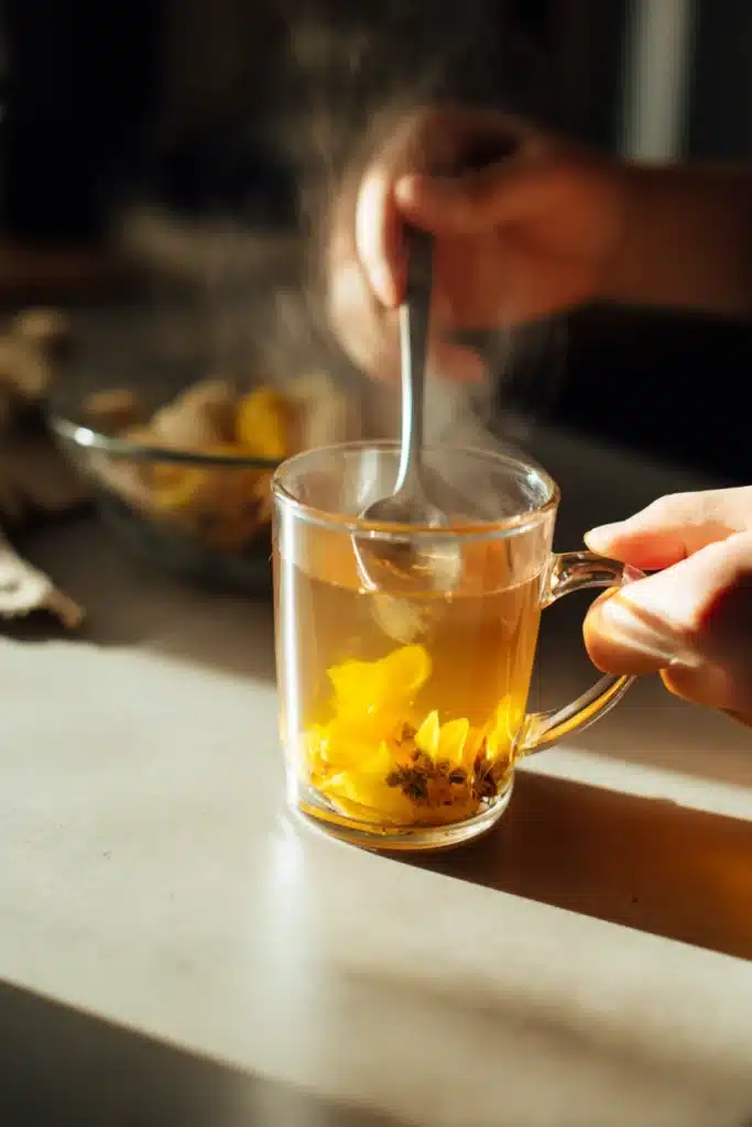 Main qui mélange la boisson de la recette du mounjaro naturel dans un mug